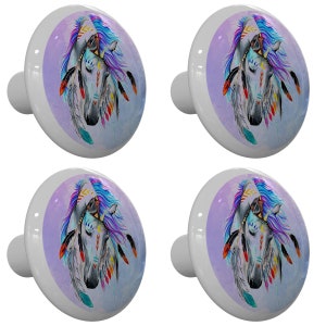 May include: Four ceramic cabinet knobs with a purple, blue, and white design of a horse's head with feathers and beads.