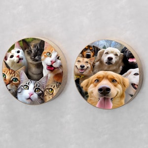 May include: Two round wooden wall decorations with a collage of cats and dogs. The left side features a group of cats looking at the camera. The right side features a group of dogs looking at the camera.