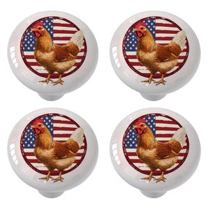 May include: A set of four round white cabinet knobs, each featuring a circular graphic of a brown chicken standing in front of a stylized American flag with red, white, and blue stripes and a blue field with white stars.