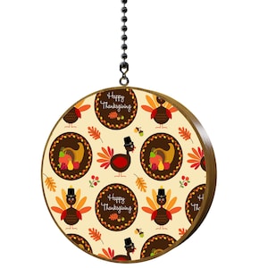May include: A round, wooden-framed Thanksgiving decoration. The design features a repeating pattern of cartoon turkeys, cornucopias, and fall leaves on a cream background. The words "Happy Thanksgiving" are in a circular frame.