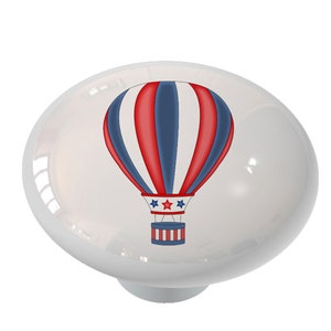 May include: A red, white, and blue hot air balloon with stars on the side. The balloon is against a white background.