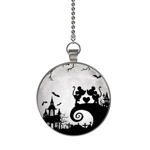 May include: A round, silver-toned ceiling fan pull featuring a Halloween-themed design. The image shows a black silhouette of a haunted house, bats, and two cartoon mice holding a heart against a full moon background.