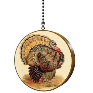 May include: A round wooden ceiling fan pull with a vintage illustration of a brown and gray turkey with a red wattle and a yellow and brown tail.