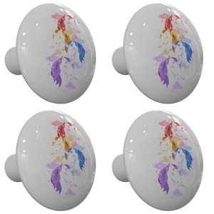 May include: Four white ceramic cabinet knobs with a rainbow unicorn design. Each knob has a silver metal stem.