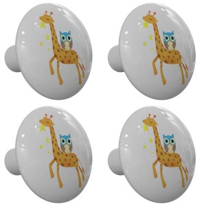 May include: Four white ceramic knobs with a cartoon giraffe and owl design. The giraffe is reaching for a star and the owl is sitting on its back. The knobs are perfect for a child's room or nursery.