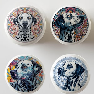May include: Four white ceramic cabinet knobs with Dalmatian dog portraits. Each knob features a different artistic rendering of a Dalmatian's face, set against ornate, colorful backgrounds. The knobs are round and have a glossy finish.