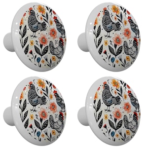 May include: Set of four ceramic knobs featuring a black and white chicken illustration with floral accents in shades of orange, yellow, and blue.