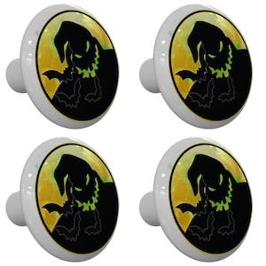 May include: Set of four ceramic cabinet knobs featuring a silhouette of the character Jack Skellington from the movie The Nightmare Before Christmas. The knobs are white with a yellow and green moon background.