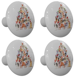 May include: Four white ceramic cabinet knobs with a Christmas tree design featuring a variety of dogs wearing Santa hats.