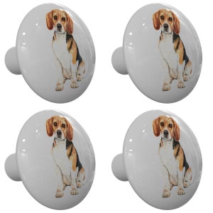 May include: Set of four ceramic cabinet knobs featuring a watercolor illustration of a beagle dog. The knobs are white with a gray background and have a silver metal screw.