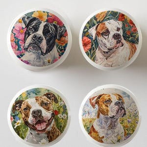 May include: Four white ceramic cabinet knobs with watercolor portraits of dogs. Each knob features a different dog breed surrounded by colorful flowers. The dogs have brown, black, and white fur.
