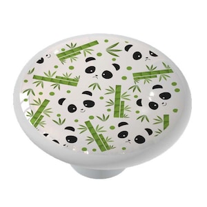 May include: White ceramic knob with a panda and bamboo pattern. The panda faces are black and white, and the bamboo is green.