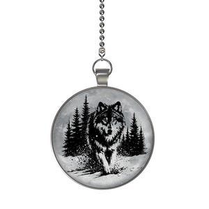 May include: A round pendant with a silver chain featuring a black and white wolf illustration. The wolf is depicted in a snowy forest scene with pine trees and a full moon in the background. The pendant is suspended from a silver chain.