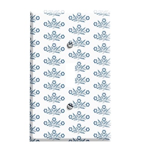 May include: White light switch cover with a blue floral pattern.