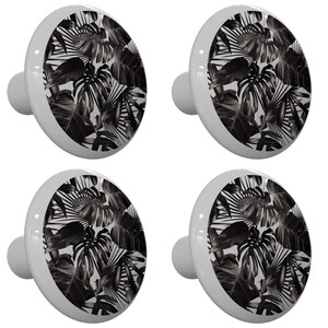 May include: Set of four white ceramic cabinet knobs with a black and white tropical leaf pattern.