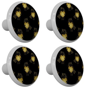 May include: Four white ceramic cabinet knobs with a black background and gold unicorn silhouettes holding hearts.