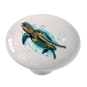 May include: A ceramic knob with a watercolor-style illustration of a sea turtle swimming in blue water. The turtle is green, blue, and yellow.