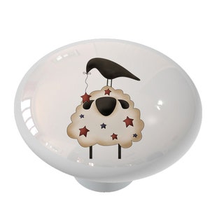 May include: A white sheep with red and blue stars on its wool, a black bird perched on top, holding a string with a star on the end.