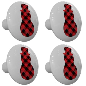 May include: Set of four white ceramic cabinet knobs with a red and black buffalo plaid snowman design.