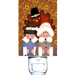 May include: A night light featuring a Thanksgiving-themed design with a turkey, a pilgrim man, and a pilgrim woman. The background is a brown pattern with sunflowers and leaves.