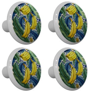 May include: Set of four ceramic cabinet knobs with a colorful banana design. The knobs feature yellow bananas with green leaves and blue accents on a white background.