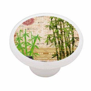 May include: White oval cabinet knob featuring a bamboo design. The knob has a cream-colored background with green bamboo stalks and leaves. The design includes a red circular stamp and Asian-inspired text.