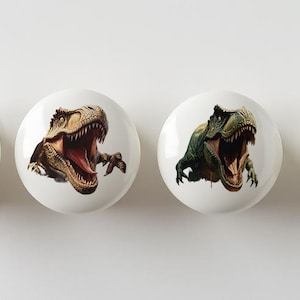 May include: Four ceramic knobs with different dinosaur designs. Each knob features a different dinosaur with an open mouth, showing teeth. The dinosaurs are in various colors, including green, brown, and blue.