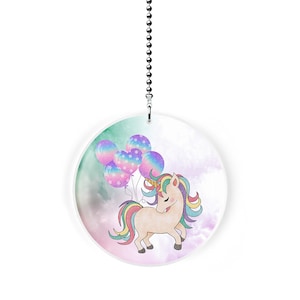 May include: A white round ceiling fan pull with a unicorn holding colorful balloons against a watercolor background.