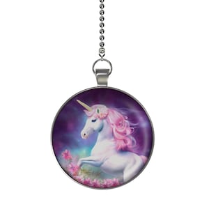 May include: A silver chain with a round pendant featuring a white unicorn with pink mane and tail, standing in a field of pink flowers against a purple galaxy background.