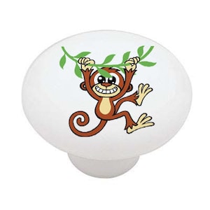 May include: A cartoon monkey with a brown body and a green vine hanging from its hands. The monkey is smiling and has big eyes. The background is white.
