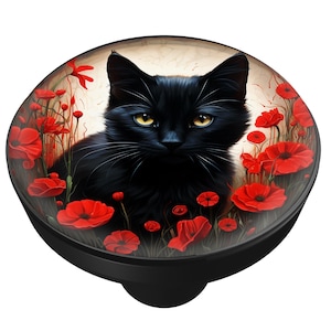 May include: A black cat with yellow eyes is surrounded by red poppies on a black, round object. The cat is the focal point, with detailed fur and a serene expression. The poppies add a vibrant contrast.