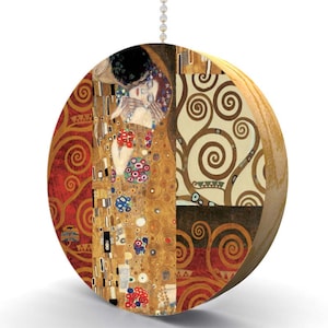 May include: A round, gold, and red pull chain with a printed image of Gustav Klimt's "The Kiss" painting. The image features two figures embracing, with a background of swirling patterns.