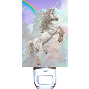 May include: A white unicorn with a rainbow in the background. The unicorn is standing on a cloud and has a horn. The night light is white and has a light bulb in the center.