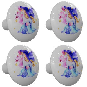 May include: Set of four white ceramic cabinet knobs with a whimsical unicorn design. Each knob features a watercolor illustration of a unicorn standing on a cloud with a starry night sky background.