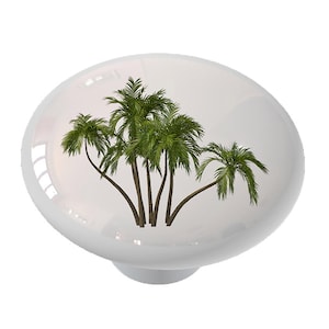 May include: White ceramic knob with a design of five palm trees on a white background.