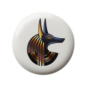 May include: A black and gold Anubis head with a white background. The Anubis head is a stylized illustration of the Egyptian god of the dead.
