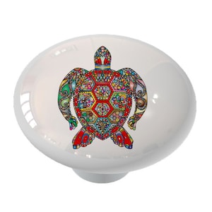 May include: A colorful ceramic knob with a detailed design of a sea turtle. The turtle is decorated with intricate patterns in shades of red, blue, green, yellow, and orange.
