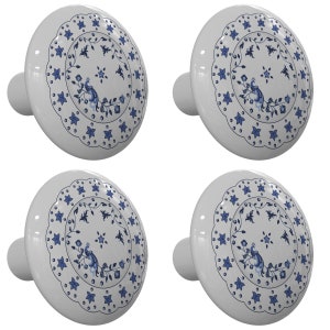 May include: Set of four white ceramic cabinet knobs with a blue and white floral design. Each knob features a stylized peacock and a circular border of blue stars.