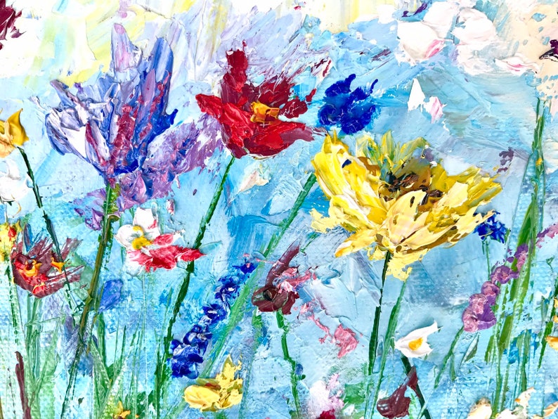 May include: An impressionistic painting of a wildflower meadow. The artwork features a variety of colorful flowers, including red, yellow, purple, and white blooms, set against a light blue background. The thick brushstrokes create a textured, vibrant effect, evoking a sense of nature and beauty.