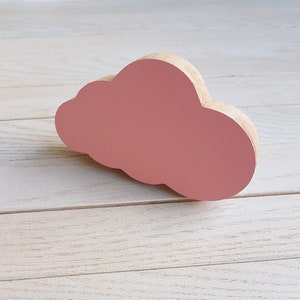 May include: A pink wooden cloud shaped ornament.