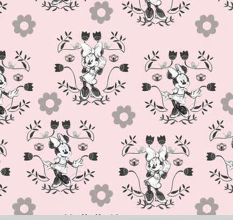 May include: A pink fabric with a repeating pattern of a black and white cartoon mouse wearing a dress and bow. The mouse is surrounded by black floral designs and grey flowers.