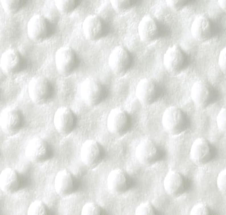 Puede incluir: Tela blanca con un patr&oacute;n texturizado de peque&ntilde;os puntos en relieve.