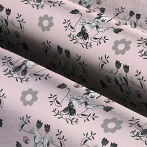 May include: Pink fabric with a repeating pattern of black and white cartoon mice, flowers, and leaves.