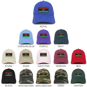 May include: A selection of baseball caps in various colours and patterns, each featuring a patch with the flag of Libya. The flag is black, red, and green with a crescent moon and star in the centre.