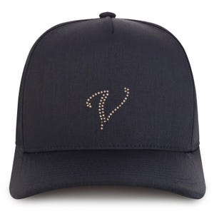May include: A navy blue baseball cap with a curved brim. The cap features a decorative letter "V" made of small, sparkling rhinestones. The cap is a solid color and has a button on top.