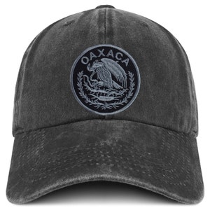 May include: A black distressed baseball cap with an embroidered patch featuring the Coat of Arms of Mexico and the word "OAXACA" in white.
