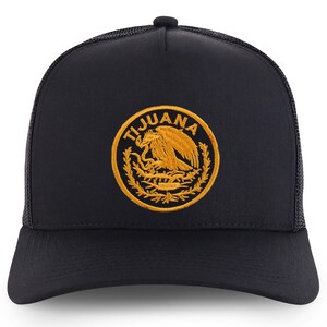May include: Black trucker hat with a gold embroidered patch featuring the Mexican coat of arms and the word "TIJUANA".