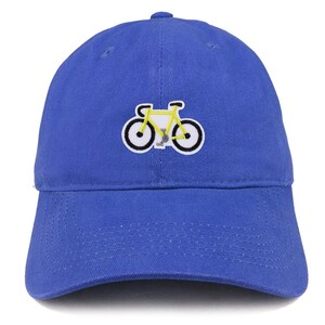 May include: A blue baseball cap featuring a yellow bicycle emblem. The bicycle has black and white wheels. The cap is made of a soft material and has a curved peak.