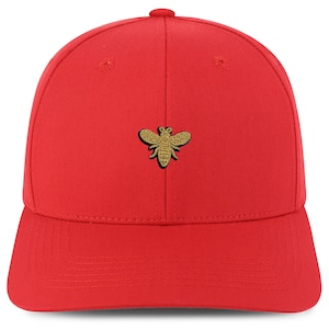 May include: A red baseball cap with a gold embroidered bee on the front.