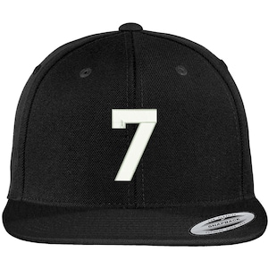 May include: Black baseball cap with a white number 7 on the front. The cap has a curved brim and a snap closure.